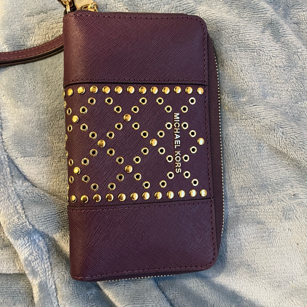 Rarely used Michael Kors wristlet-purple with gold studs